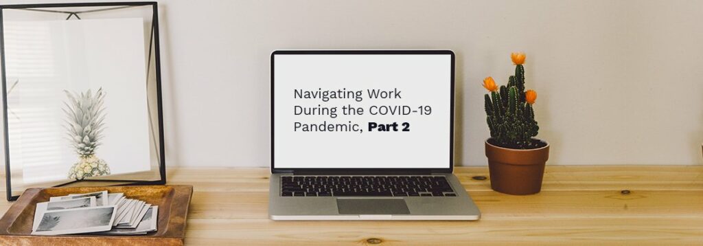 A laptop on a wooden desk displays the text Navigating Work During the COVID-19 Pandemic, Part 2. The desk also has a cactus in a pot, a pineapple, and a tray with photos.